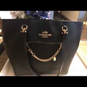 Black leather Coach tote with gold accents